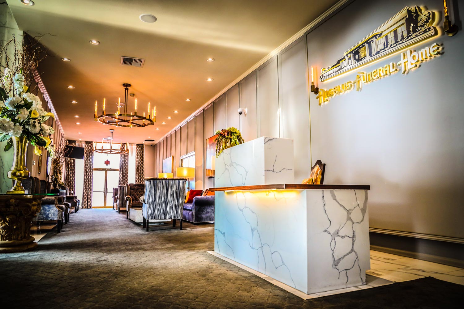 The marble front desk and gold Angelus Funeral Home signage