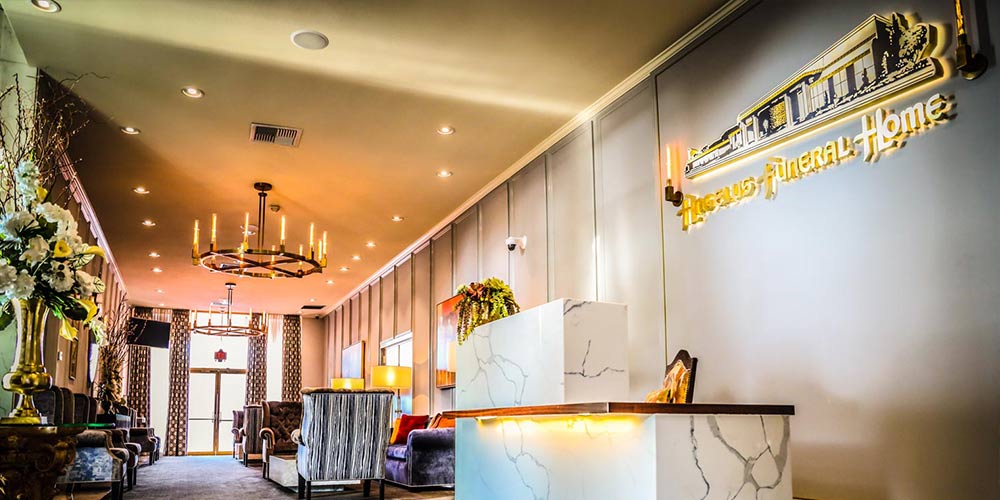 The elegant marble lobby of Angelus Funeral Home with gold signage